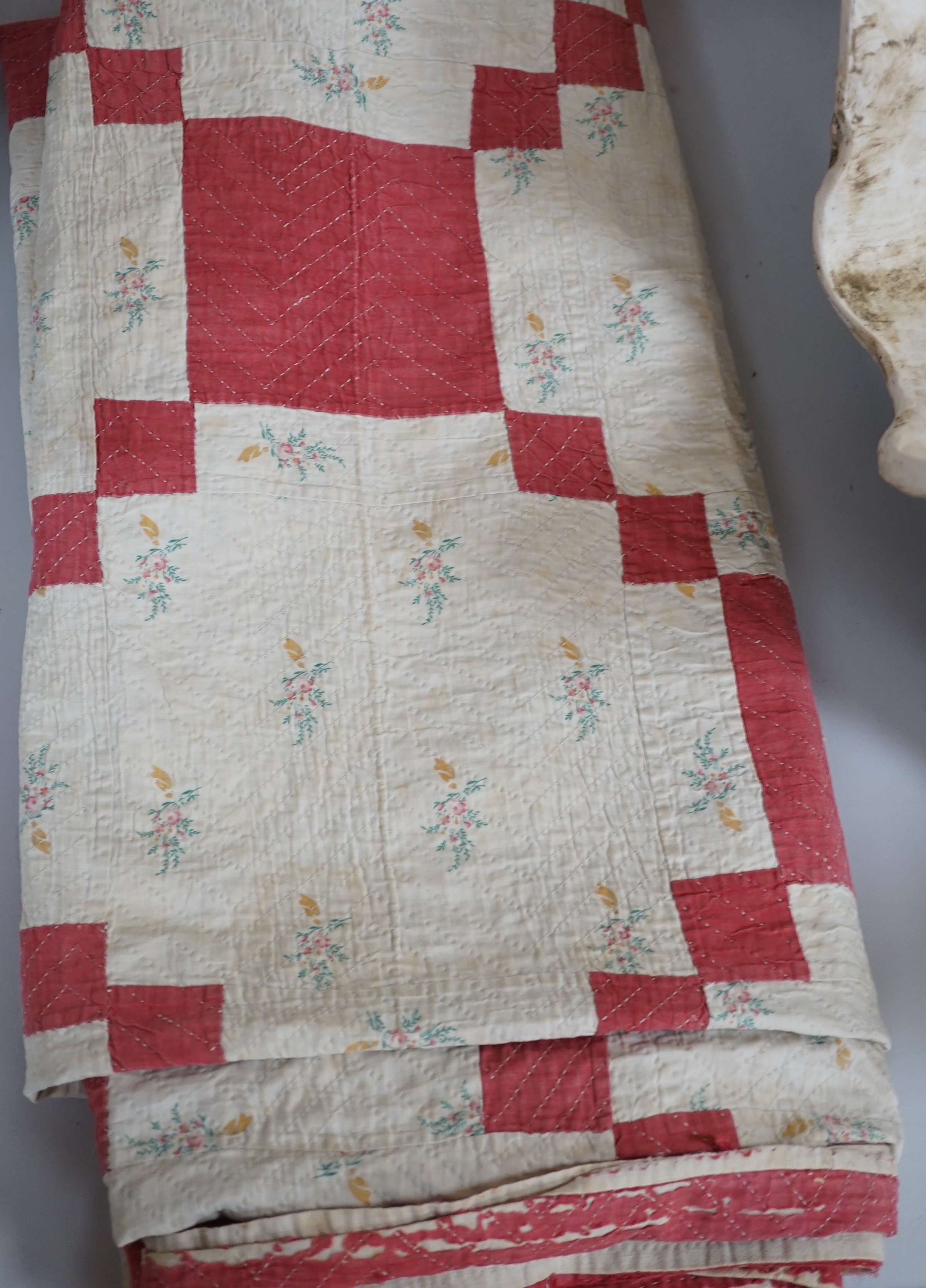 A mid to late 19th century hand stitched patch worked quilt, 210 cms x 200 cms